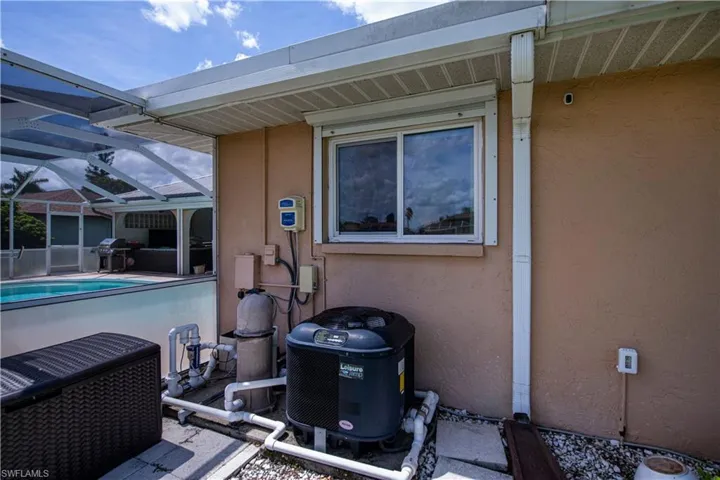 View of patio / terrace featuring pool heater and screen enclosure
