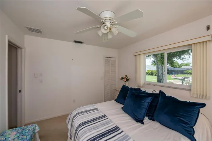 Guest bedroom featuring ceiling fan and wlk-in closet