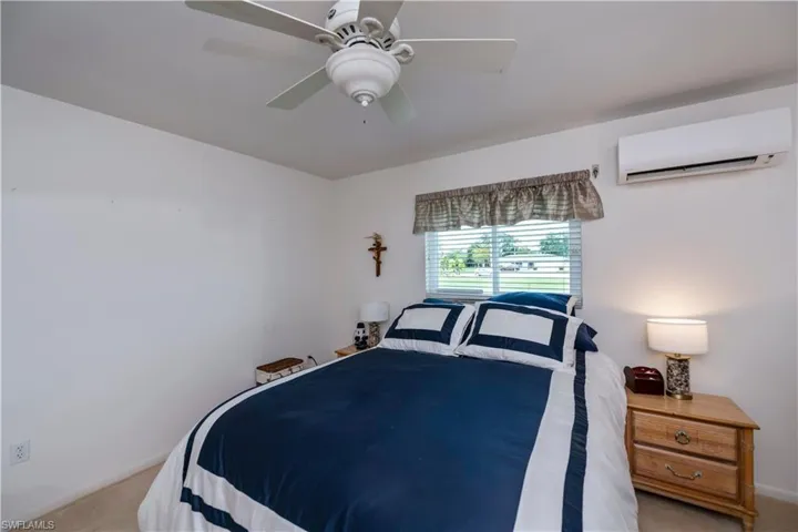 Guest bedroom with a walk-in closet and ceiling fan