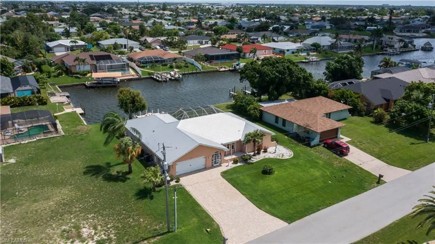 Birds eye view of property with a water view
