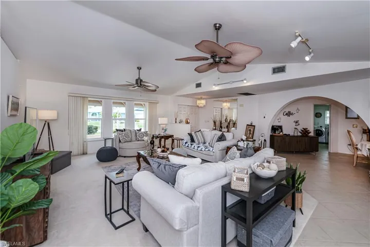 Large living room with ceiling fan, vaulted ceiling, track lighting