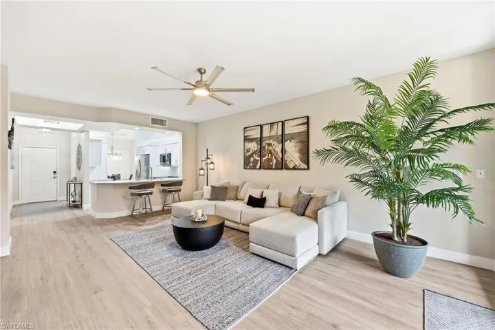 Living area with light wood-style flooring and ceiling fan