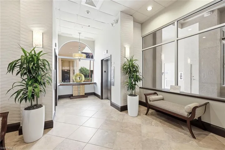 Building lobby featuring a paneled ceiling and a high ceiling
