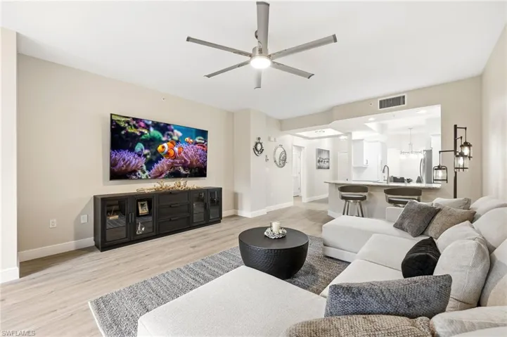 Living area featuring light wood finished floors and ceiling fan