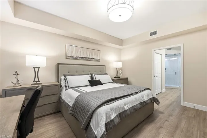 Bedroom with light wood finished floors and baseboards