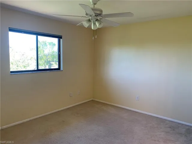 Master bedroom featuring light carpet and ceiling fan