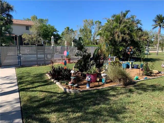 View of home's community featuring a yard