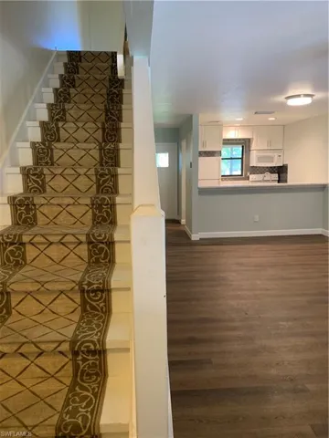 Stairs featuring hardwood / wood-style floors
