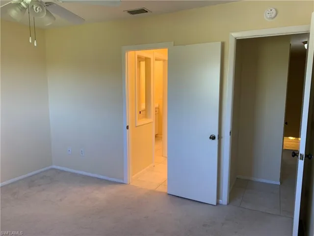 Master bedroom featuring ceiling fan and light carpet