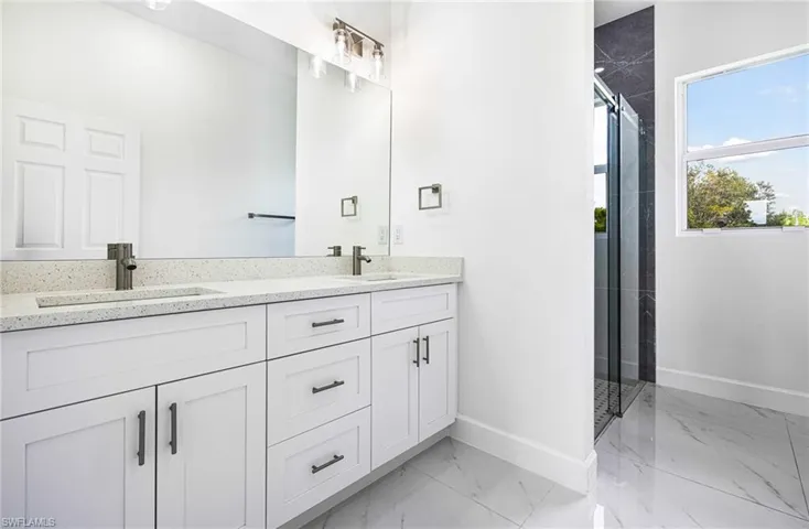 Bathroom featuring vanity and an enclosed shower