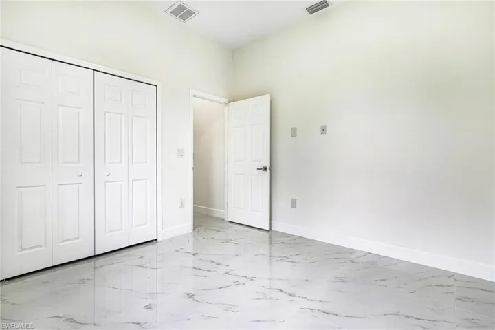 Unfurnished bedroom with a closet