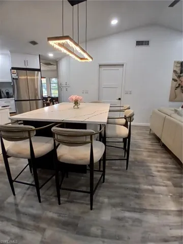 Spacious kitchen island featuring a light-toned countertop with dark veining