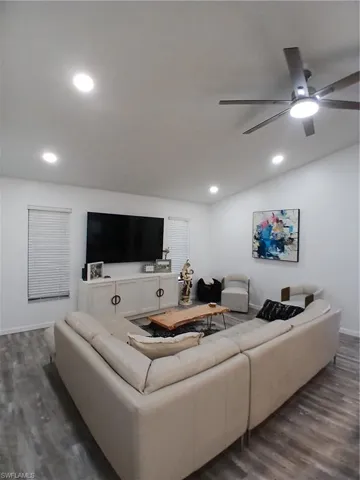 Living space featuring recessed lighting, a modern ceiling fan, and wood-finish flooring