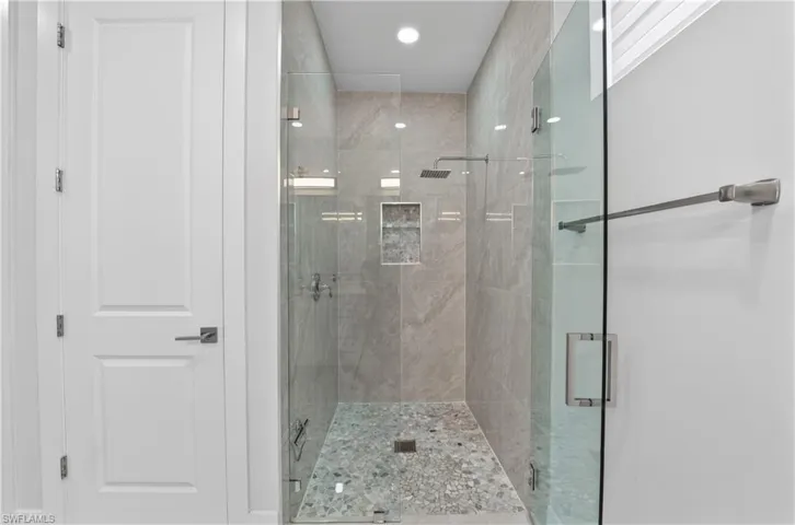 Bathroom with a shower stall and recessed lighting
