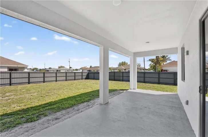 Fenced backyard featuring a patio area and a residential view