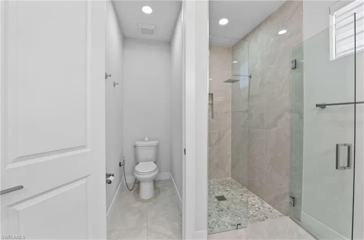Full bathroom featuring a shower stall and recessed lighting
