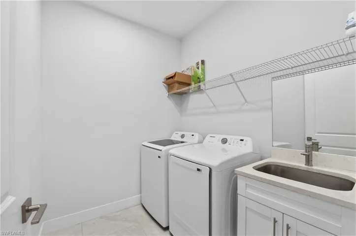 Laundry room featuring separate washer and dryer and cabinet space