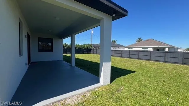 Fenced backyard with a patio