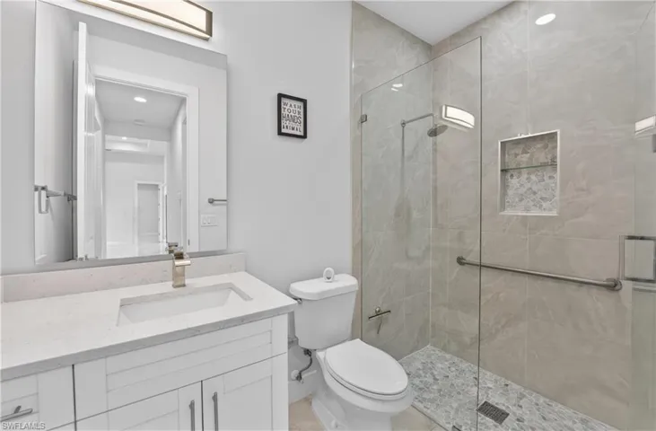 Bathroom with a stall shower and vanity