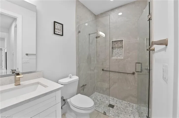 Full bath featuring vanity and a shower stall