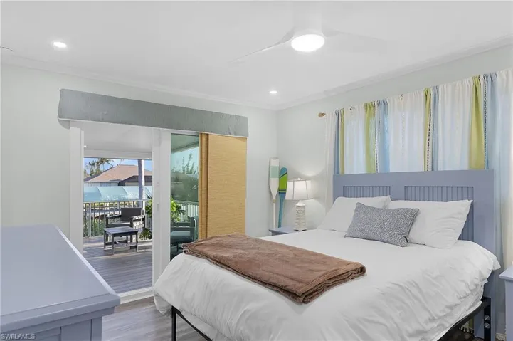 Bedroom with wood-finish flooring, recessed lighting, and a ceiling fan