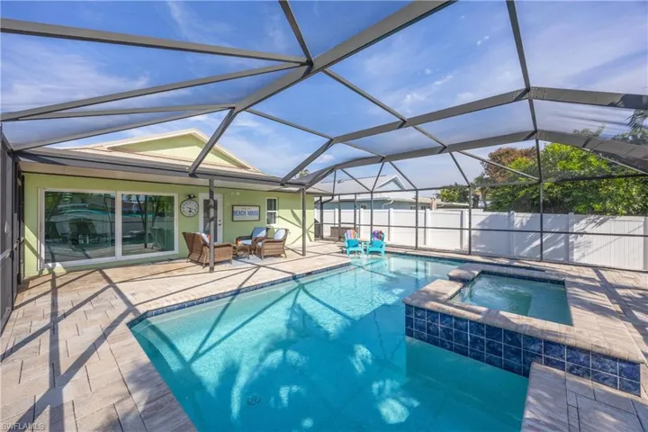 View of the spacious swimming pool, spa and screened lanai area.