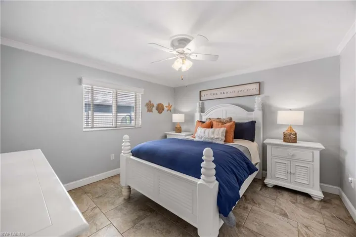 Guest bedroom 2 is tastefully trimmed with crown molding and mellow tones.