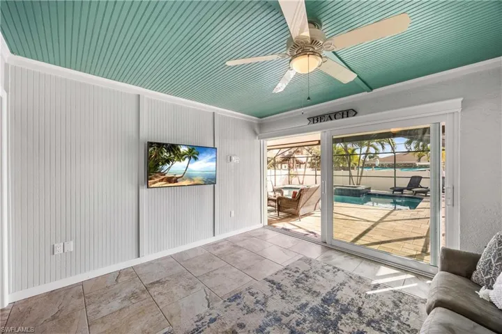 Kick back in the cozy den watching the large flat screen TV with views of the pool and spa.