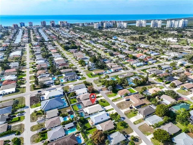 Aerial view of property's location with nearby suburban area and a large body of water