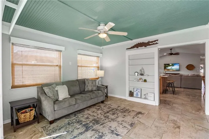 Kick back in the cozy den watching the large flat screen TV with views of the pool and spa.