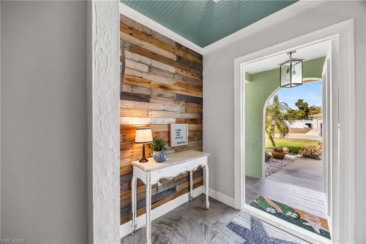Sunny entry way featuring custom wood trims.