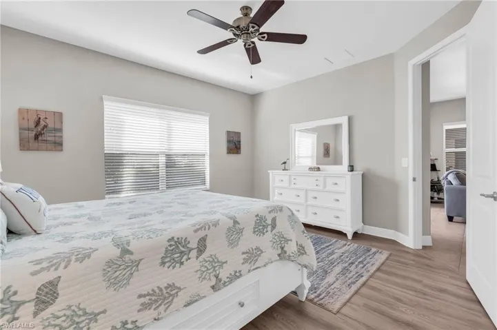 Bedroom with ceiling fan and light wood-type flooring