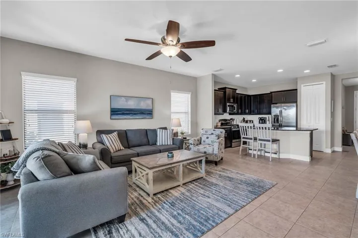 Tiled living room featuring ceiling fan
