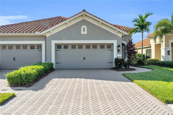 Mediterranean / spanish-style home with a garage and a front yard