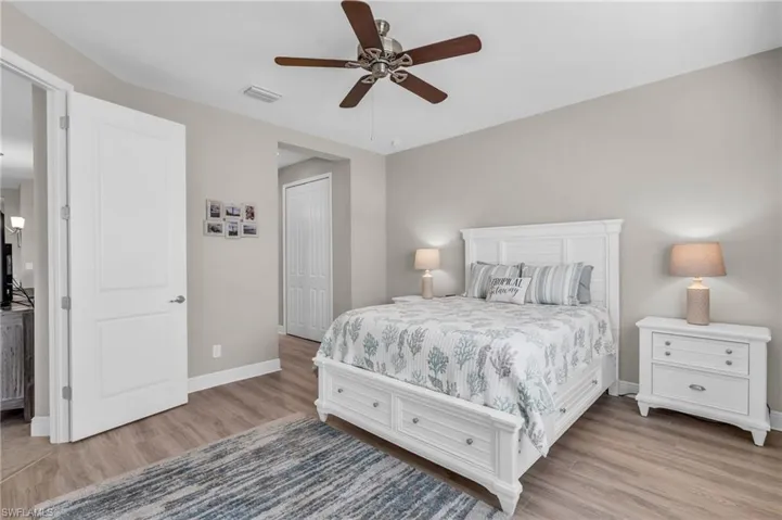 Bedroom featuring ceiling fan, light wood-type flooring, and a closet