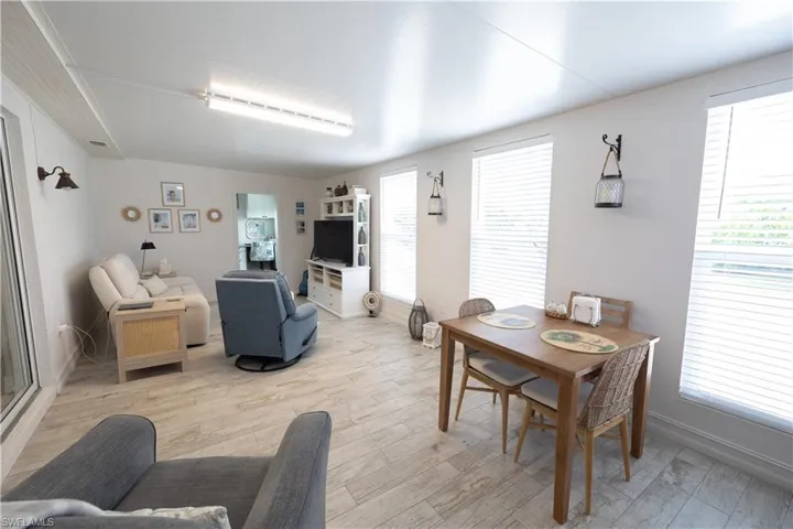 Dining area featuring light wood-style floors and baseboards