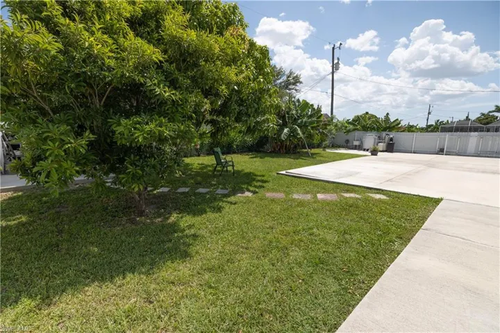 View of yard featuring driveway and a patio area