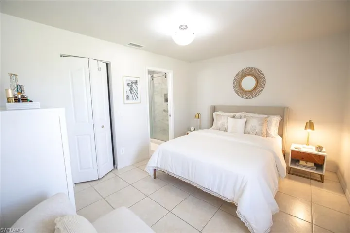 Master Bedroom featuring light tile patterned floors and connected bathroom
