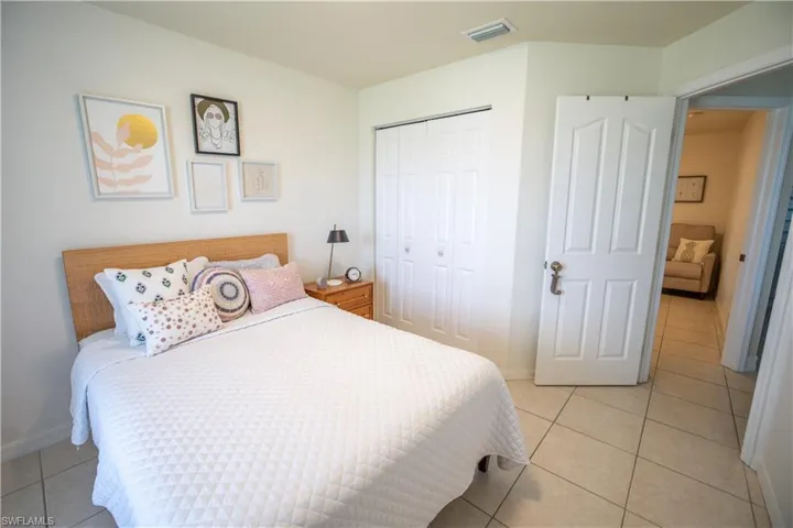 Bedroom with a closet and light tile patterned floors