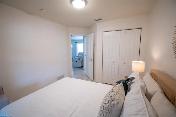 Bedroom with a closet and light tile patterned floors