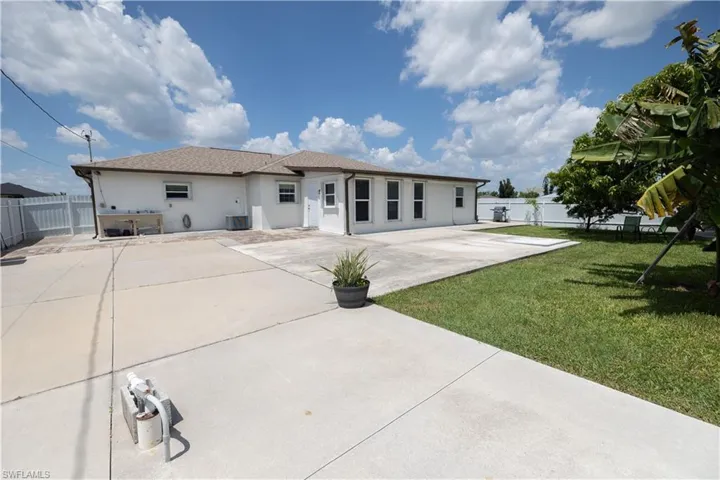 Rear view of property featuring a patio area, a fenced backyard, and stucco siding