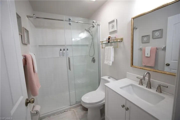 Full bath featuring a shower stall and vanity