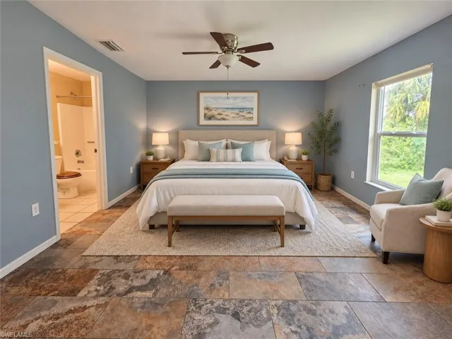 Spacious room featuring multi-toned tile flooring, a large window, and an attached full bathroom with a tub and shower combination
