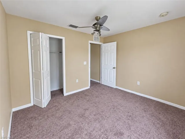 Neutral-toned walls complement the textured carpeting