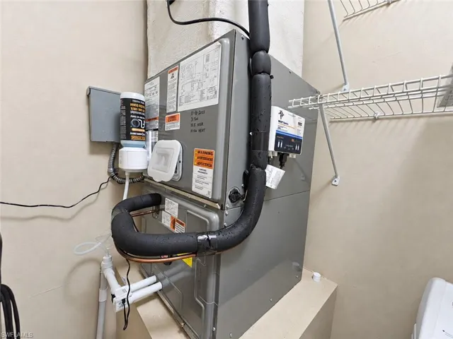HVAC system with visible conduits and wiring, complemented by wire shelving