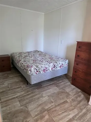Bedroom with a textured ceiling