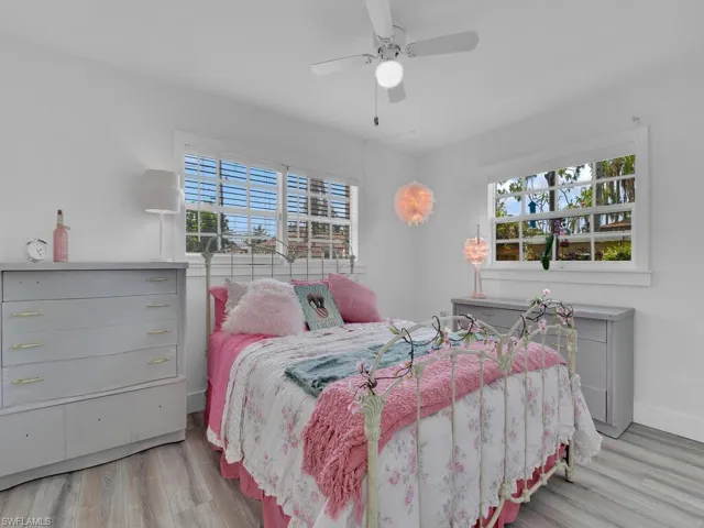 Bedroom with light vinyl wood-style flooring and ceiling fan