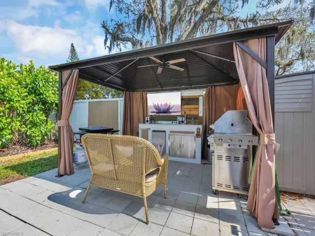 View of patio with additional area for grilling, an outdoor kitchen, and a gazebo
