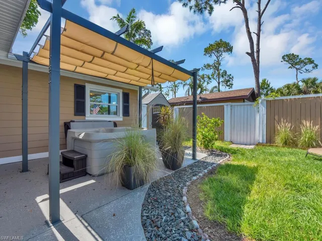 View of yard with a hot tub and a shed