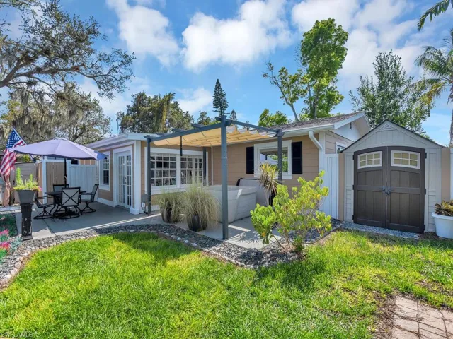 View of yard with a hot tub and a shed